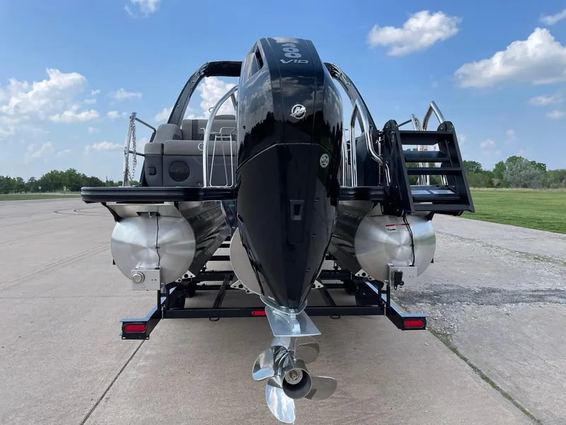 Slide: The Image of 2023 Barletta Lusso 25UCA pontoon boat on trailer, rear view, outdoors. - 10