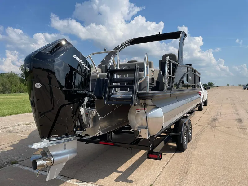Slide: The Image of 2023 Barletta Lusso 25UCA pontoon boat with Mercury engine on trailer. - 12