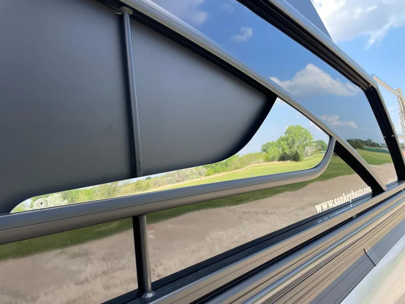 Slide: The Image of 2023 Barletta Lusso 25UCA boat exterior with sleek design and reflective surface. - 19