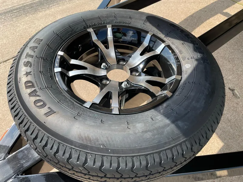 Slide: The Image of 2023 Barletta Lusso 25UCA tire with black alloy wheel on a trailer. - 21