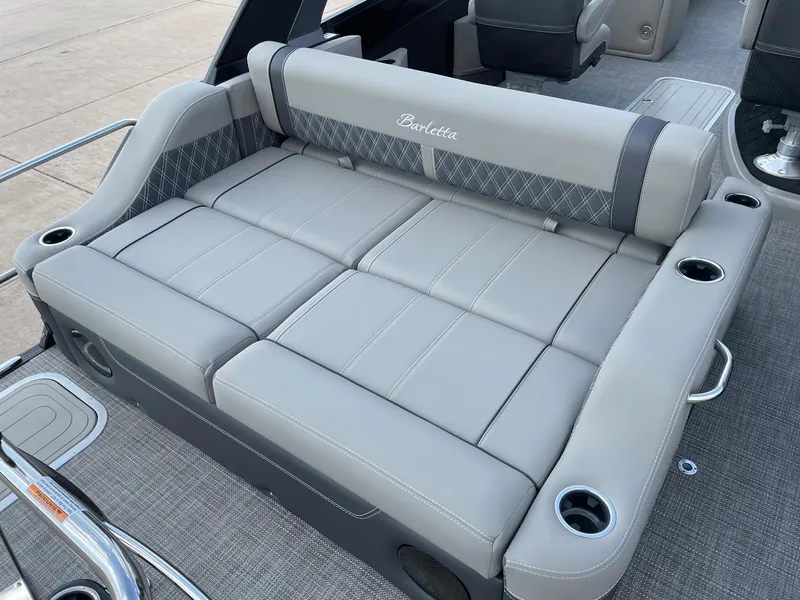 Slide: The Image of 2023 Barletta Lusso 25UCA boat seating with gray upholstery and cup holders. - 29