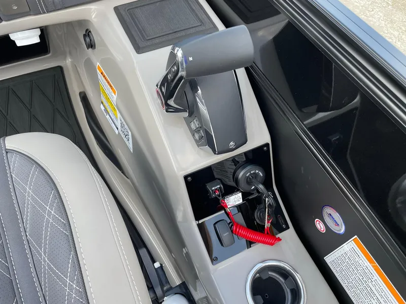 Slide: The Image of 2023 Barletta Lusso 25UCA boat control panel with throttle and cup holder. - 32