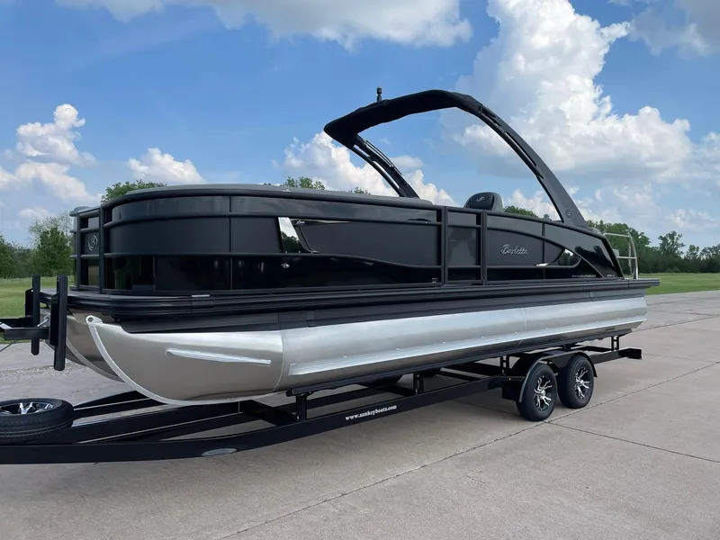 Slide: The Image of 2023 Barletta Lusso 25UCA pontoon boat on trailer, sleek design, black and silver finish. - 4