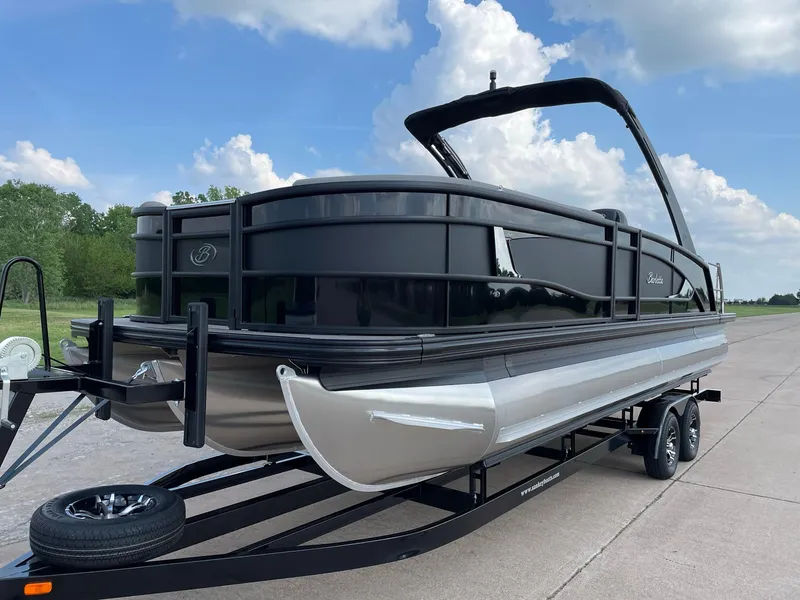Slide: The Image of 2023 Barletta Lusso 25UCA pontoon boat on trailer, sleek design, black finish. - 5