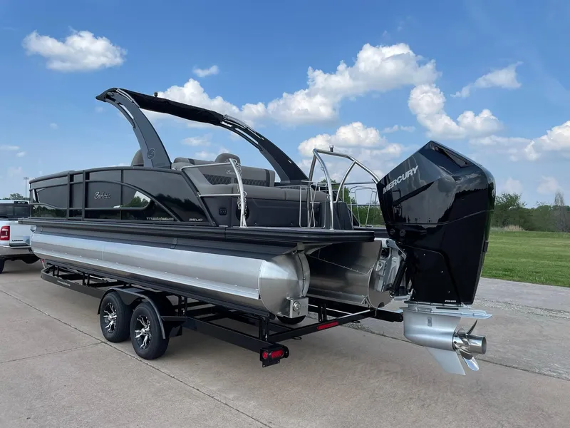 Slide: The Image of 2023 Barletta Lusso 25UCA pontoon boat on trailer, featuring sleek design and powerful engine. - 8