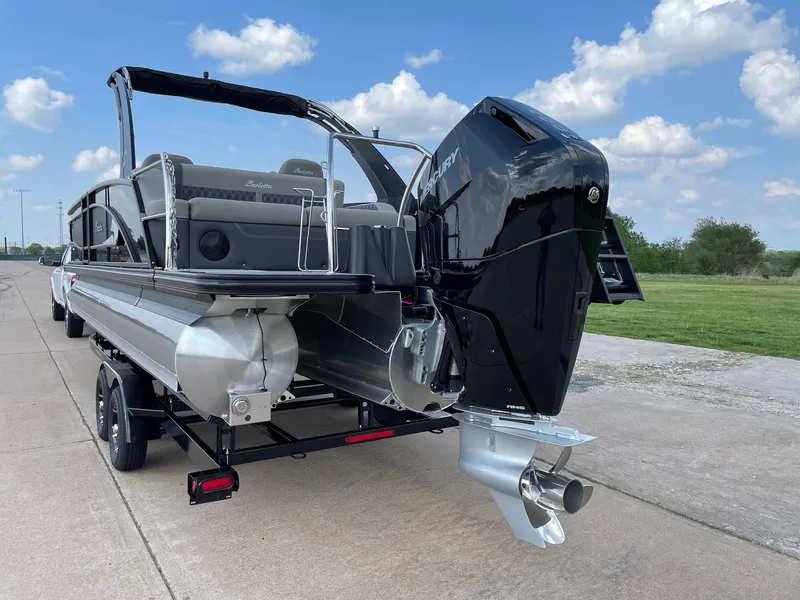 Slide: The Image of 2023 Barletta Lusso 25UCA pontoon boat with powerful outboard motor on trailer. - 9