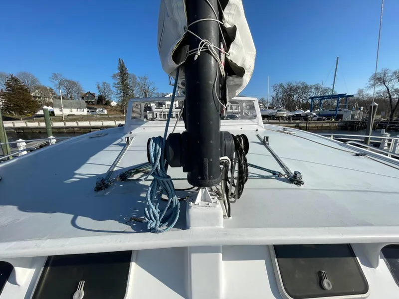 Slide: The Image of 1991 Crowther Custom 46 sailboat deck with mast and rigging, docked under clear blue sky. - 10