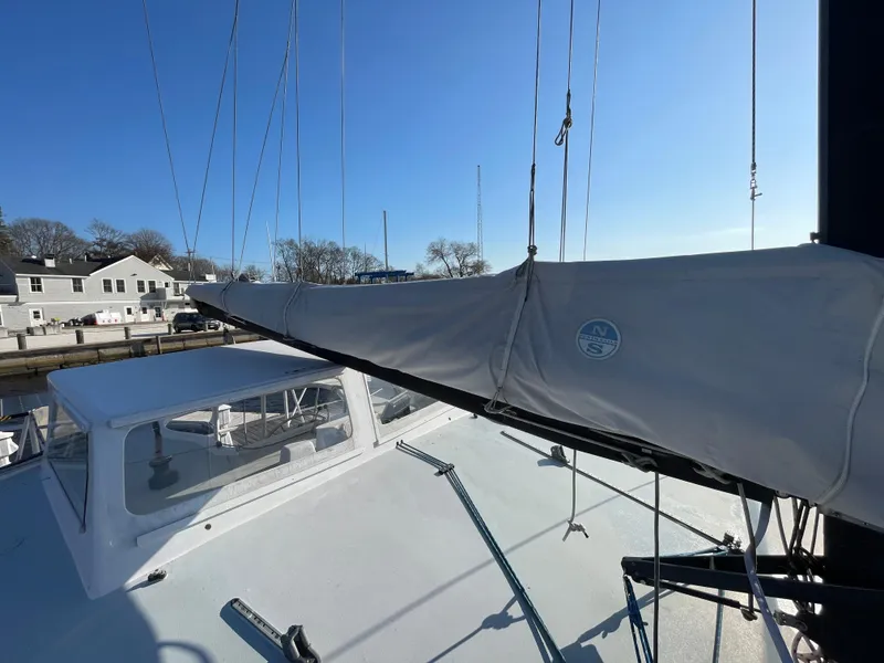Slide: The Image of Sailboat Crowther Custom 46, 1991 model, docked with covered sail and clear sky. - 12