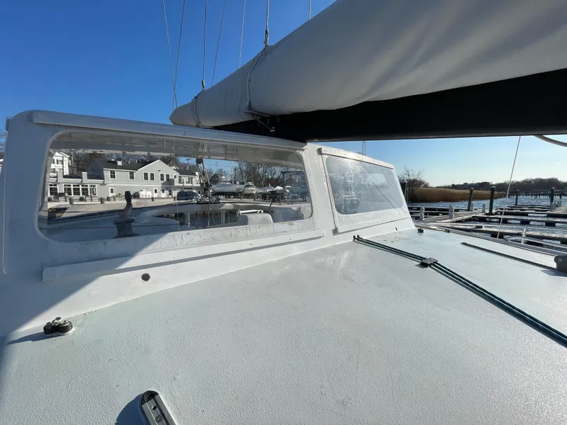 Slide: The Image of Sailboat Crowther Custom 46, 1991 model, docked with clear skies and marina view. - 13