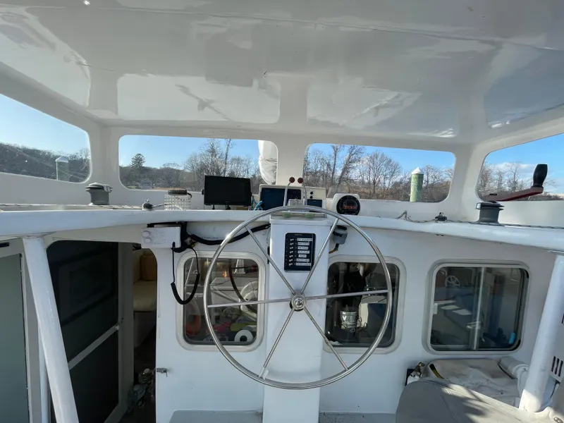 Slide: The Image of Helm of 1991 Crowther Custom 46 sailboat with steering wheel and navigation equipment. - 14