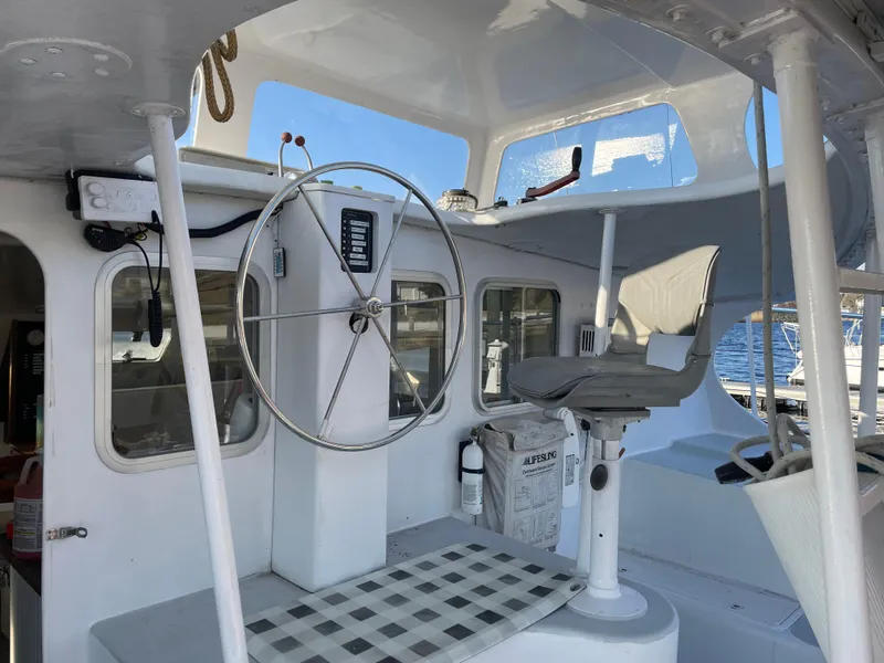 Slide: The Image of Cockpit of 1991 Crowther Custom 46 sailboat with steering wheel and seating. - 16