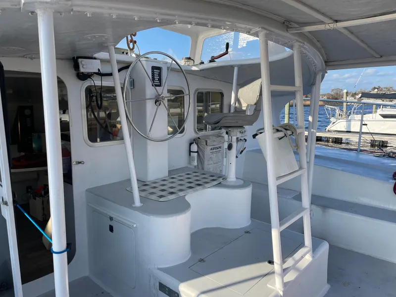 Slide: The Image of Cockpit of 1991 Crowther Custom 46 sailboat with steering wheel and ladder. - 17