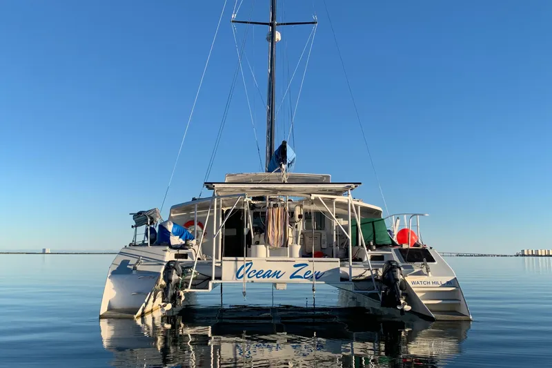 Slide: The Image of 1991 Crowther Custom 46 catamaran on calm water, clear sky background. - 2