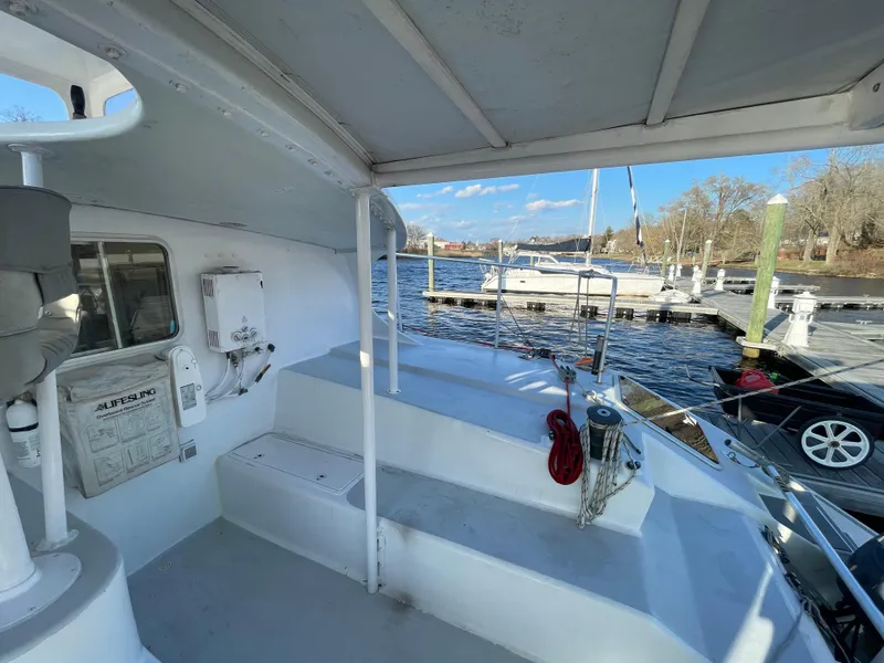 Slide: The Image of Crowther Custom 46 yacht deck, 1991 model, docked at marina with clear blue sky. - 22