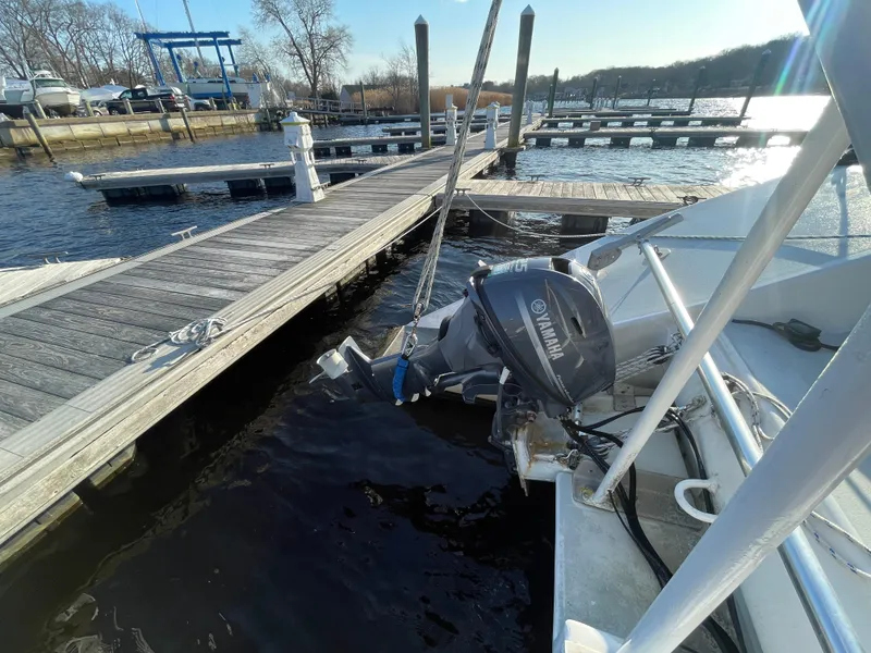 Slide: The Image of 1991 Crowther Custom 46 docked with Yamaha outboard motor, sunny marina setting. - 23