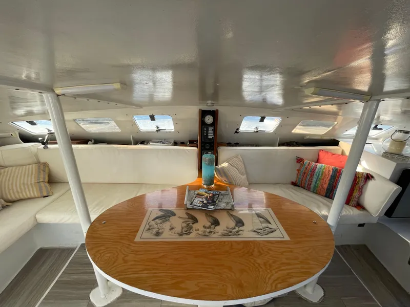 Slide: The Image of Interior of 1991 Crowther Custom 46 yacht with cozy seating and round wooden table. - 26