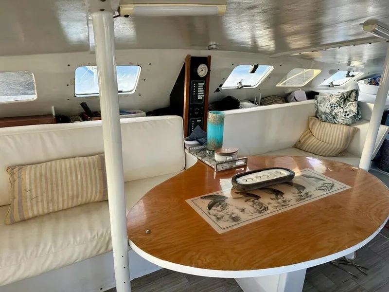 Slide: The Image of Interior of 1991 Crowther Custom 46 yacht with cozy seating and wooden table. - 27