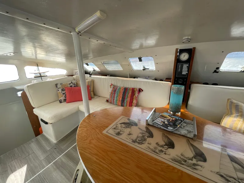 Slide: The Image of Interior of 1991 Crowther Custom 46 yacht with cozy seating and nautical decor. - 28