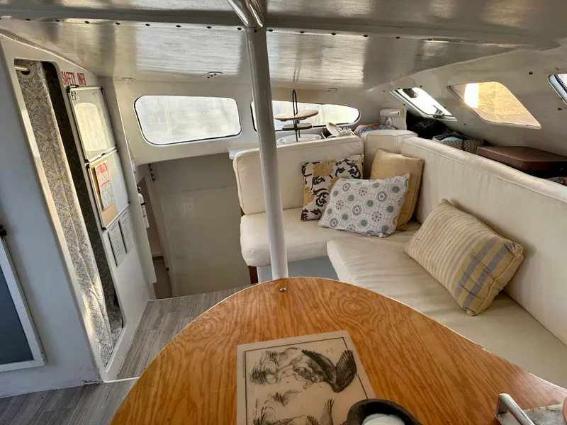 Slide: The Image of Interior of 1991 Crowther Custom 46 yacht with cozy seating and decorative pillows. - 29