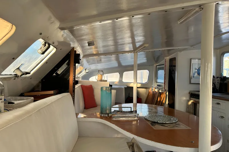 Slide: The Image of Interior of 1991 Crowther Custom 46 yacht with modern seating and dining area. - 33