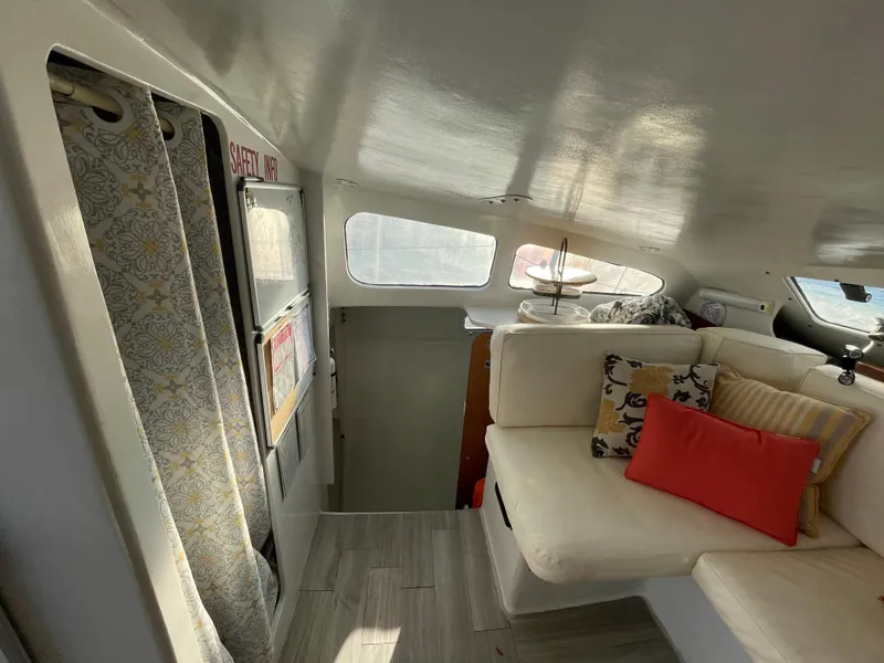 Slide: The Image of Interior of 1991 Crowther Custom 46 yacht with cozy seating and decorative pillows. - 34