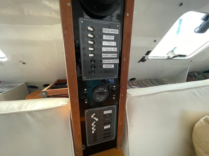 Slide: The Image of Control panel inside 1991 Crowther Custom 46 sailboat, featuring switches and gauges. - 35