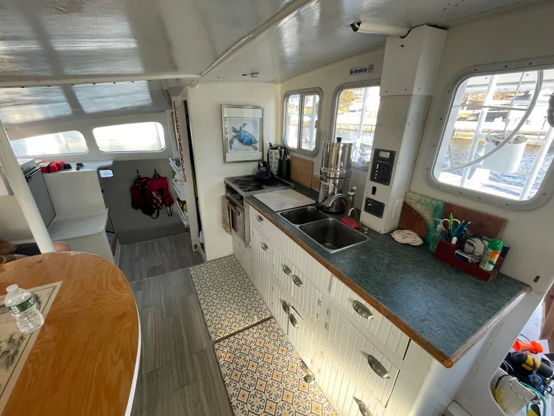 Slide: The Image of Interior of 1991 Crowther Custom 46 yacht with kitchen and seating area. - 36
