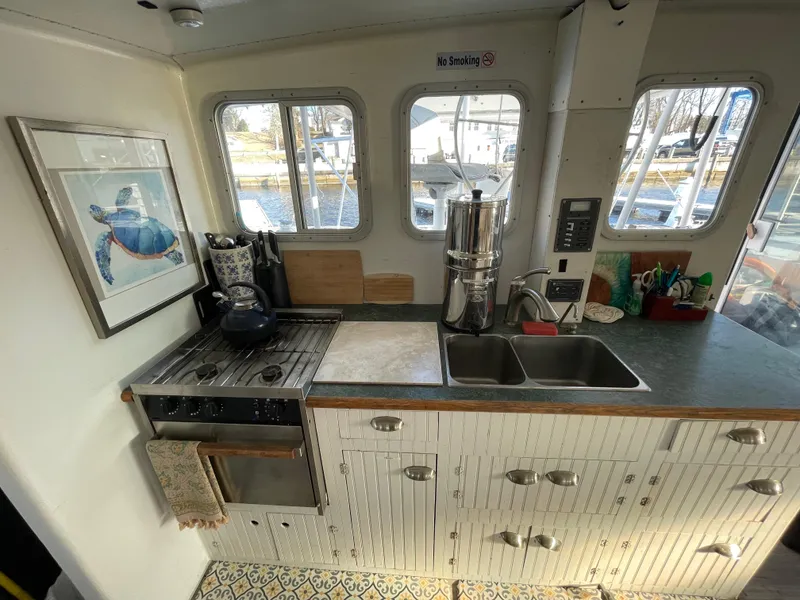 Slide: The Image of Cozy kitchen in 1991 Crowther Custom 46 yacht with stove, sink, and nautical decor. - 37