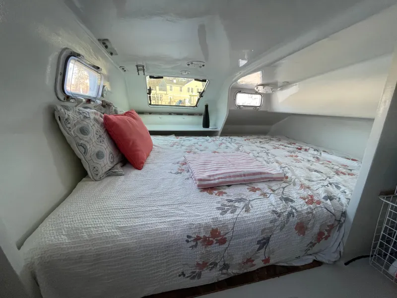 Slide: The Image of Cozy bedroom inside a 1991 Crowther Custom 46 yacht, featuring floral bedding and porthole windows. - 38