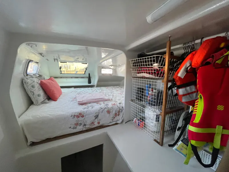 Slide: The Image of Interior of 1991 Crowther Custom 46 yacht with cozy bed and organized storage. - 39
