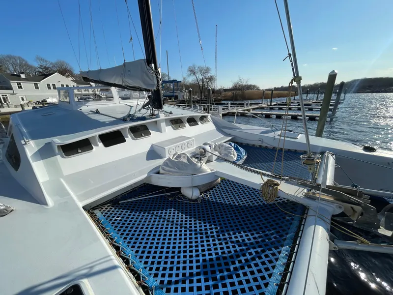 Slide: The Image of Sailing yacht Crowther Custom 46, 1991 model, docked with blue netting and clear sky. - 4