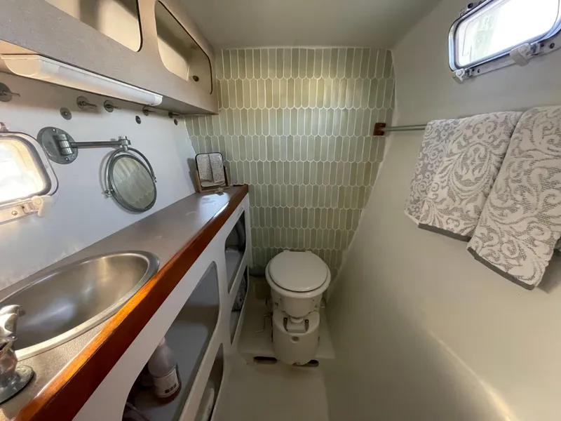 Slide: The Image of Bathroom interior of 1991 Crowther Custom 46 yacht with sink, toilet, and towels. - 41