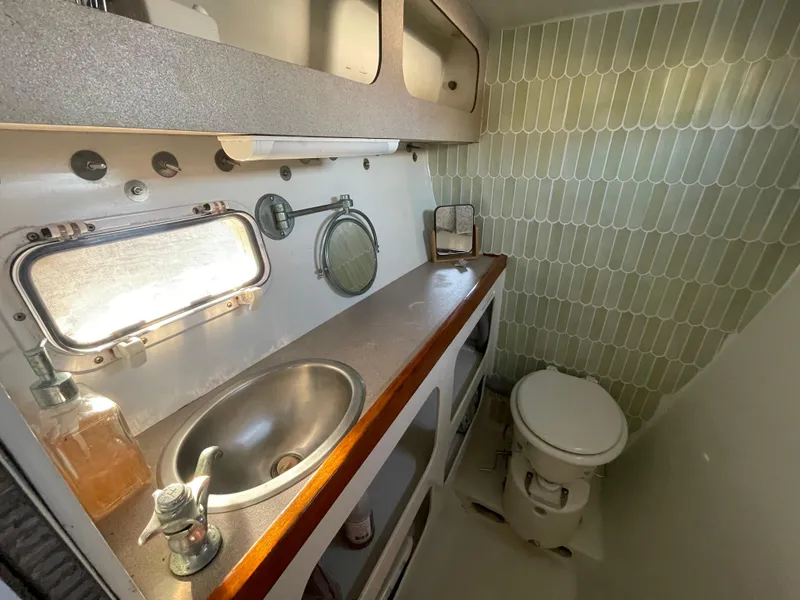 Slide: The Image of Bathroom interior of 1991 Crowther Custom 46 yacht with sink, toilet, and porthole. - 42
