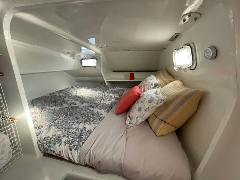 Slide: The Image of Cozy cabin interior of 1991 Crowther Custom 46 sailboat with bed and portholes. - 43
