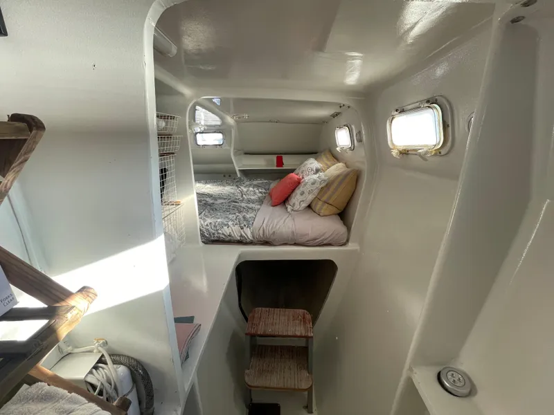 Slide: The Image of Interior of 1991 Crowther Custom 46 yacht with cozy bed and porthole windows. - 44