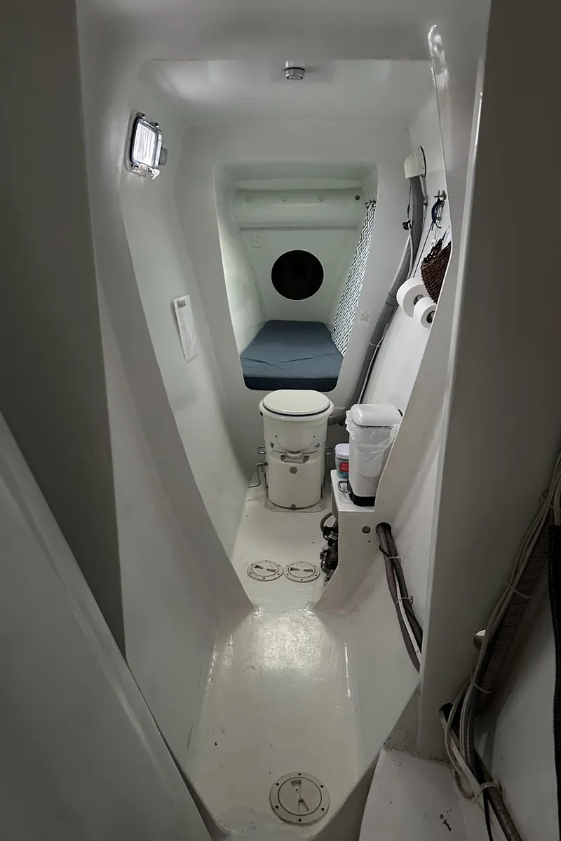 Slide: The Image of Interior of 1991 Crowther Custom 46 sailboat, featuring compact bathroom and sleeping area. - 47