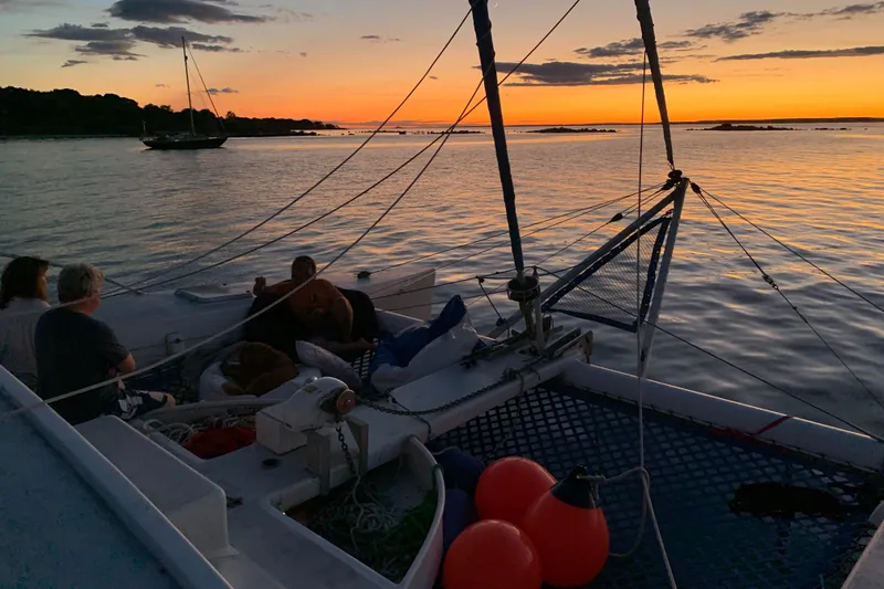 Slide: The Image of Crowther Custom 46 sailboat at sunset, 1991 model, with people relaxing on deck. - 48
