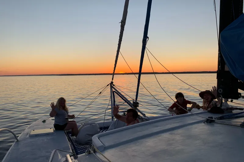 Slide: The Image of People relaxing on a 1991 Crowther Custom 46 catamaran at sunset. - 49