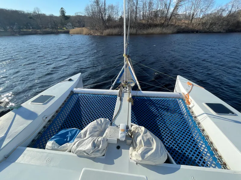Slide: The Image of 1991 Crowther Custom 46 catamaran on calm water, featuring blue netting and sails. - 6