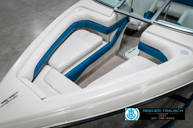 Slide: The Image of 1995 Crownline 182 BR boat interior with white and blue seating. - 12