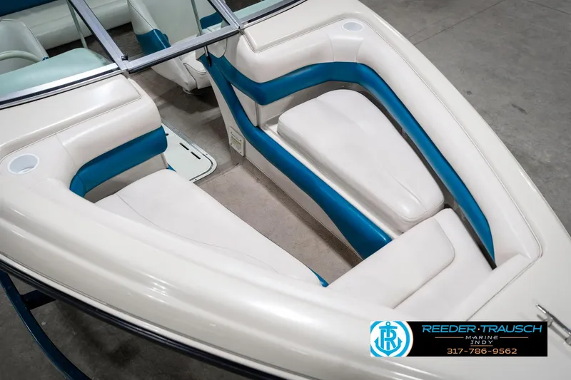 Slide: The Image of 1995 Crownline 182 BR boat interior with white and blue seating. - 13