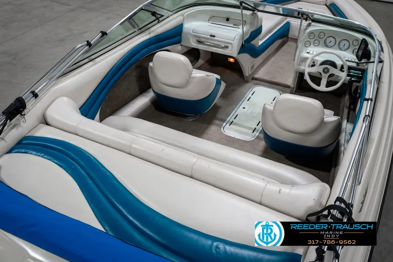Slide: The Image of 1995 Crownline 182 BR boat interior with white and blue seating. - 14