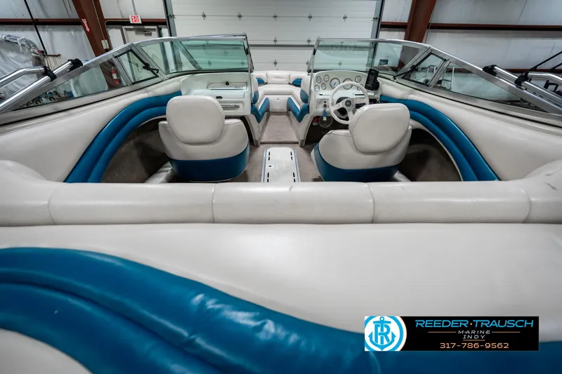 Slide: The Image of Interior of a 1995 Crownline 182 BR boat with blue and white seating. - 16