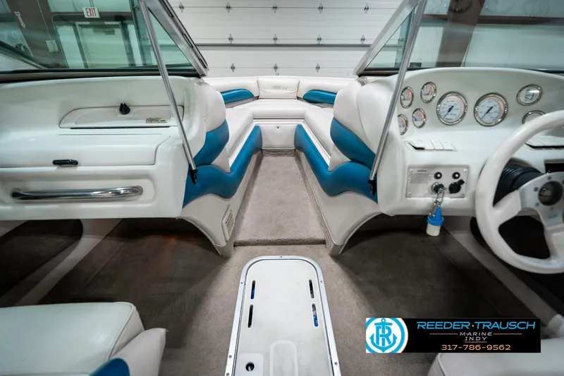 Slide: The Image of Interior of a 1995 Crownline 182 BR boat with blue and white seating. - 17