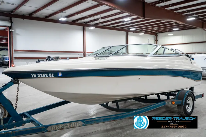 Slide: The Image of 1995 Crownline 182 BR boat on trailer in indoor storage facility. - 2