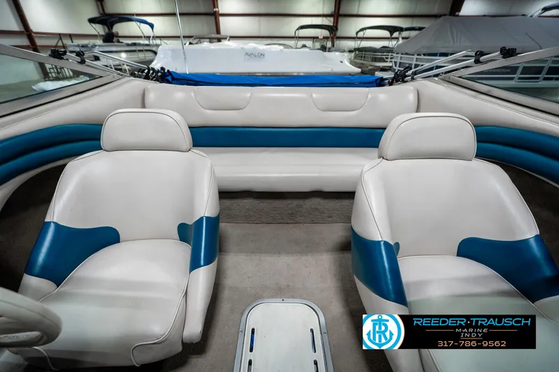Slide: The Image of Interior of a 1995 Crownline 182 BR boat with white and blue seating. - 20