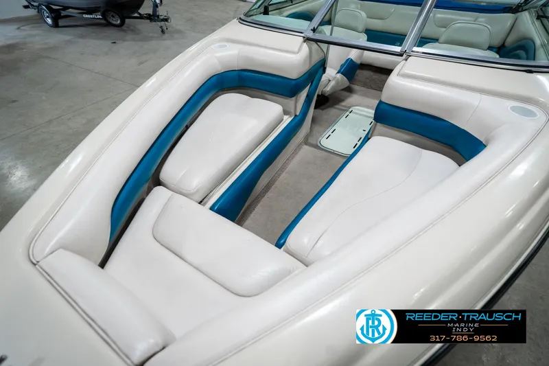 Slide: The Image of 1995 Crownline 182 BR boat interior with white and blue seating. - 22