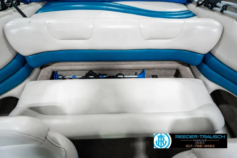 Slide: The Image of Interior of a 1995 Crownline 182 BR boat with white and blue seating. - 25
