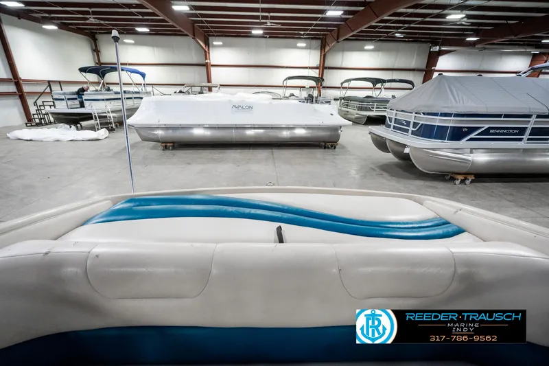 Slide: The Image of Indoor storage of various boats, including a 1995 Crownline 182 BR, in a spacious facility. - 26