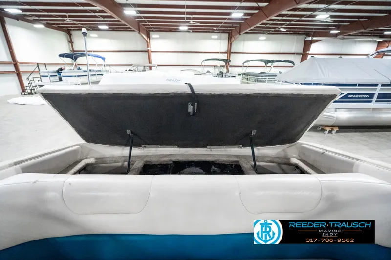 Slide: The Image of 1995 Crownline 182 BR boat interior with open engine compartment in a showroom. - 27
